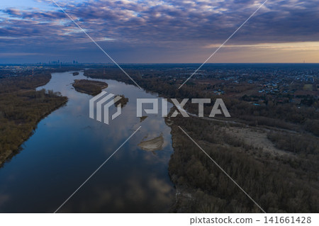 Aerial dusk view of Vistula River with Warsaw skyline at left Aerial dusk view of Vistula River with Warsaw skyline at left 141661428