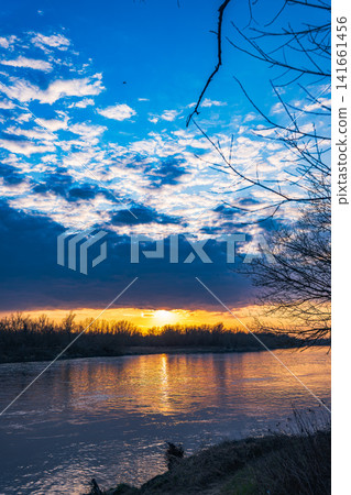 Vistula River near Warsaw at sunset with layered clouds and riverbank Vistula River near Warsaw at sunset with layered clouds and riverbank 141661456