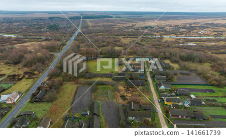 Aerial rural Belarus landscape with straight road, village, wetlands Aerial rural Belarus landscape with straight road, village, wetlands 141661739