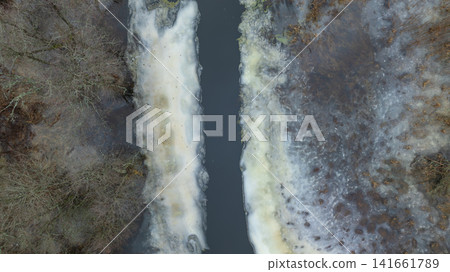 Aerial river corridor between thawing ice in Belarus winter Aerial river corridor between thawing ice in Belarus winter 141661789