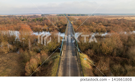 Aerial bridge over flooded wetland in rural Belarus during thaw Aerial bridge over flooded wetland in rural Belarus during thaw 141661808