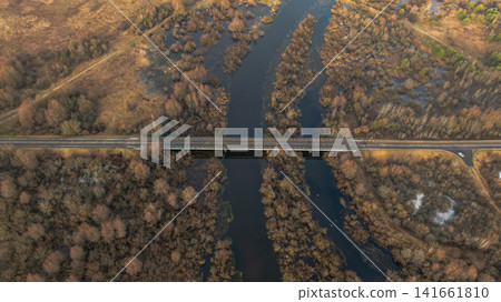 Aerial winter bridge over winding river and wetlands in Belarus 141661810