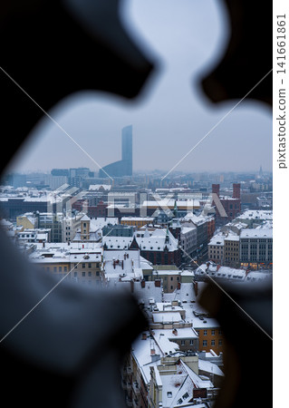 Wroclaw winter cityscape framed by stone opening with Sky Tower Wroclaw winter cityscape framed by stone opening with Sky Tower 141661861