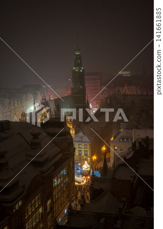 Snowy night in Wroclaw Old Town with Old Town Hall tower aglow Snowy night in Wroclaw Old Town with Old Town Hall tower aglow 141661885