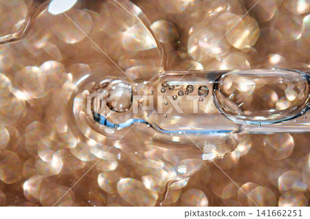 Cosmetics serum pipette dropping liquid with bubbles Cosmetics serum pipette dropping liquid with bubbles 141662251