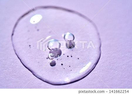Serum drop with bubbles on purple background Serum drop with bubbles on purple background 141662254