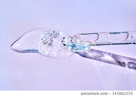 Skincare serum drops from pipette on surface 141662255