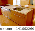 Open kitchen with wood grain finish 141662260
