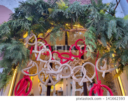 Garlands of Christmas tree branches with Christmas toys and kalachs hang above the entrance. The concept of Christmas and New Year Garlands of Christmas tree branches with Christmas toys and kalachs hang above the entrance. The concept of Christmas and New Year 141662393