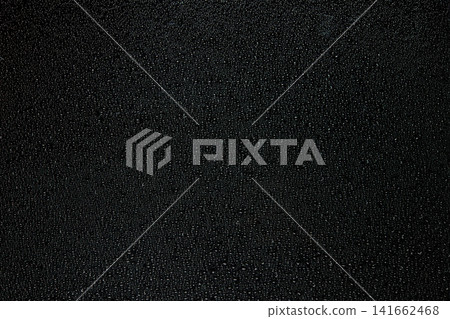 A macro close-up photograph of condensation with countless water droplets on a black background. 141662468