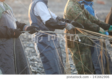 Fishermen pulling nets from the shore Fishermen pulling nets from the shore 141662906