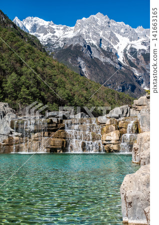 Waterfalls at the foothill of Jade Dragon Snow Mountain in Yulong Naxi Autonomous County, Lijiang, in Yunnan province, China. Waterfalls at the foothill of Jade Dragon Snow Mountain in Yulong Naxi Autonomous County, Lijiang, in Yunnan province, China. 141663165