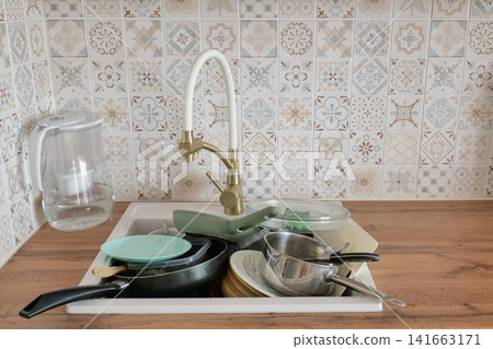 Dirty Dishes in Kitchen Sink After Meal Dirty Dishes in Kitchen Sink After Meal 141663171