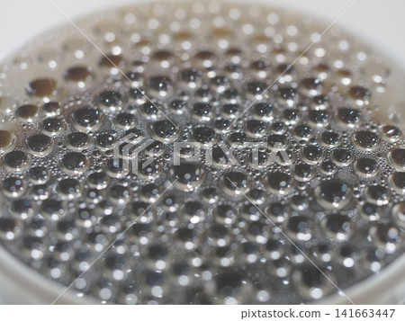Macro pattern of spreading water droplets Macro pattern of spreading water droplets 141663447