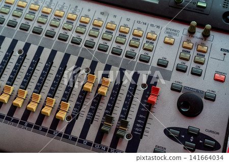 Audio sound mixer console. Sound mixing desk. Music mixer control panel in recording studio. Audio mixing console with faders and adjusting knob. Sound engineer. Sound mixer control radio broadcasting Audio sound mixer console. Sound mixing desk. Music mixer control panel in recording studio. Audio mixing console with faders and adjusting knob. Sound engineer. Sound mixer control radio broadcasting 141664034