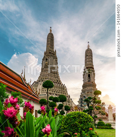 Wat Arun Ratchawararam Buddhist temple with blue sky in Bangkok, Thailand. Ancient architecture, cultural heritage, and famous travel destination. historic Buddhist architecture, cultural tourism. Wat Arun Ratchawararam Buddhist temple with blue sky in Bangkok, Thailand. Ancient architecture, cultural heritage, and famous travel destination. historic Buddhist architecture, cultural tourism. 141664050