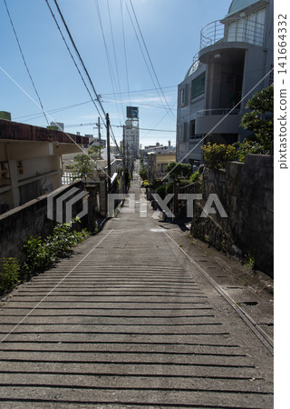 Long, straight back alleys in a sunny city, with the shadows of utility poles and houses cast across the road. Long, straight back alleys in a sunny city, with the shadows of utility poles and houses cast across the road. 141664332