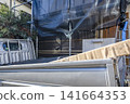 New siding materials delivered to the exterior wall renovation site. 141664353