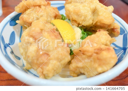 Toritamaten Bukkake Udon, generously topped with chicken tempura. Toritamaten Bukkake Udon, generously topped with chicken tempura. 141664705