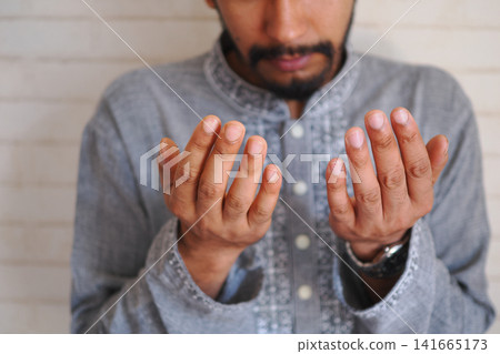 Hands raised in prayer during a quiet moment Hands raised in prayer during a quiet moment 141665173