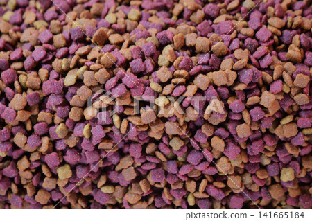 Pet food in various colors stacked in a pile 141665184