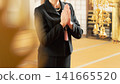 The hands of a woman in mourning attire offering a prayer. The hands of a woman in mourning attire offering a prayer. 141665520