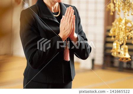 A woman's hands clasped together in silence. A woman's hands clasped together in silence. 141665522