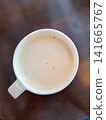 Top view of white coffee cup filled with creamy beverage on wooden table surface 141665767