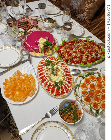 Colorful festive table setting with various traditional dishes and desserts for celebration Colorful festive table setting with various traditional dishes and desserts for celebration 141665771