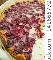 Baked cranberry pie with golden crust and filling, slice removed, served in white dish 141665772