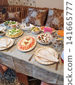 Traditional Middle Eastern dining table set with various dishes and decorative tableware 141665777