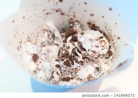 Soft serve ice cream dessert topped with chocolate cookies Soft serve ice cream dessert topped with chocolate cookies 141666073