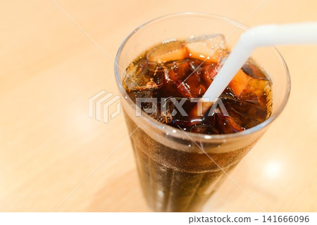 Enjoy a summer drink: iced coffee served in a glass with plenty of ice. Enjoy a summer drink: iced coffee served in a glass with plenty of ice. 141666096