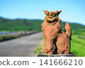 The majestic Shisa statues at Ishigaki Island's Sokohara Dam stand proudly against a backdrop of blue sky and green mountains. 141666210