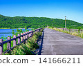 The refreshing scenery of the Sokohara Dam on Ishigaki Island, where the blue sky and deep green mountain range are reflected on the water's surface. 141666211