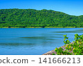 The beautiful scenery of the Sokohara Dam on Ishigaki Island, with its calm blue lake surface and deep green mountains. 141666213