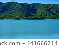 The beautiful scenery of the Sokohara Dam on Ishigaki Island, with its calm blue lake surface and deep green mountains. 141666214