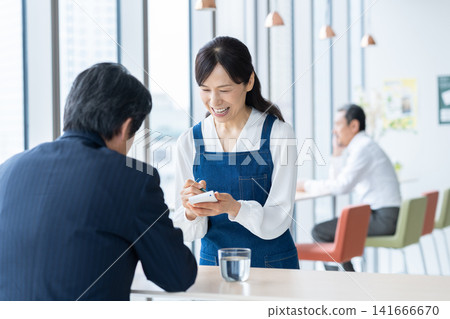 A middle-aged woman working at a cafe. Photography assistance provided by: Denpa Gakuen Educational Foundation, Tokyo Electronics College. A middle-aged woman working at a cafe. Photography assistance provided by: Denpa Gakuen Educational Foundation, Tokyo Electronics College. 141666670