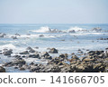 A beautiful coastal landscape where rocky cliffs stretch into the distance and the blue sea meet. 141666705