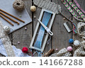 Flat lay weaving and macrame workspace with loom shuttle threads crochet hooks comb lace and craft accessories on rustic wooden table background 141667288