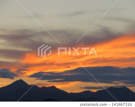 The orange sunset sky paints the mountain range. Japan, Gunma The orange sunset sky paints the mountain range. Japan, Gunma 141667310