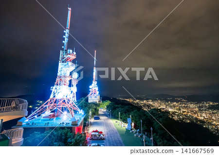 The illuminated radio tower on the summit of Mt. Inasa and the night view of Nagasaki. The illuminated radio tower on the summit of Mt. Inasa and the night view of Nagasaki. 141667569