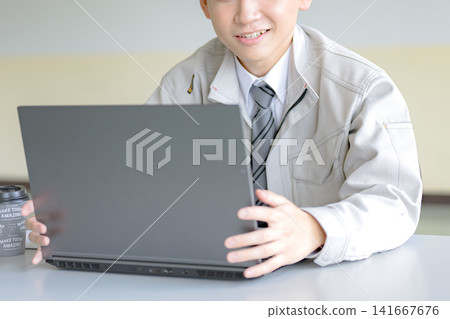 A businessman opening his laptop; an image of starting work. A businessman opening his laptop; an image of starting work. 141667676