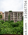The ruins of the coal mine apartments on Ikeshima Island and the vertical orientation of the ivy-covered exterior walls. 141667704
