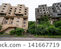 Two high-rise apartment buildings stand side by side on Ikeshima Island, seemingly facing each other. 141667719
