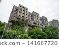 A ruined concrete high-rise apartment building stands silently on Ikeshima Island. 141667720