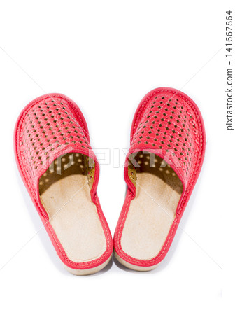 Red women's slippers on a white background Red women's slippers on a white background 141667864