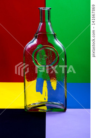 Abstract still life with a glass bottle on a colored background Abstract still life with a glass bottle on a colored background 141667869