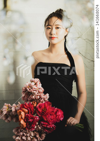 A woman in a black dress A woman in a black dress 141668074