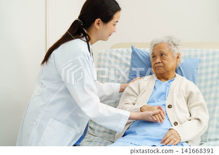 Asian doctor checking and treat elderly woman patient health in hospital. Asian doctor checking and treat elderly woman patient health in hospital. 141668391